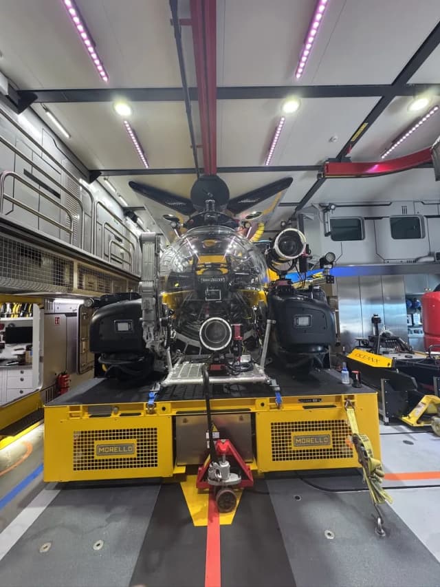 An OceanX submersible in the hangar aboard OceanXplorer