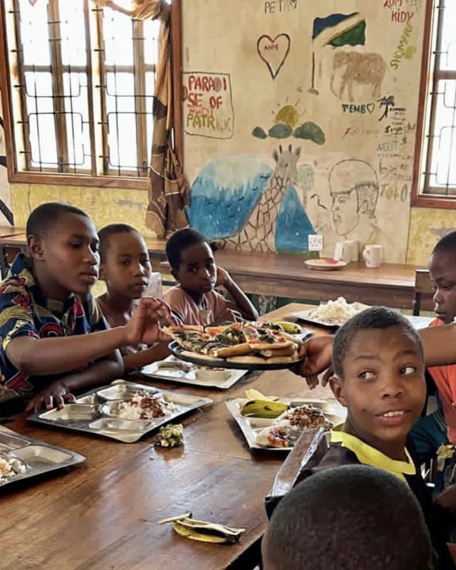 Children sharing pizza at lunch